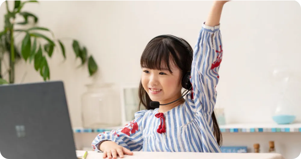オンラインレッスンで手をあげている女の子の写真